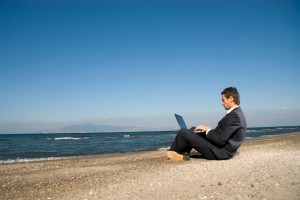 Emailing on the beach